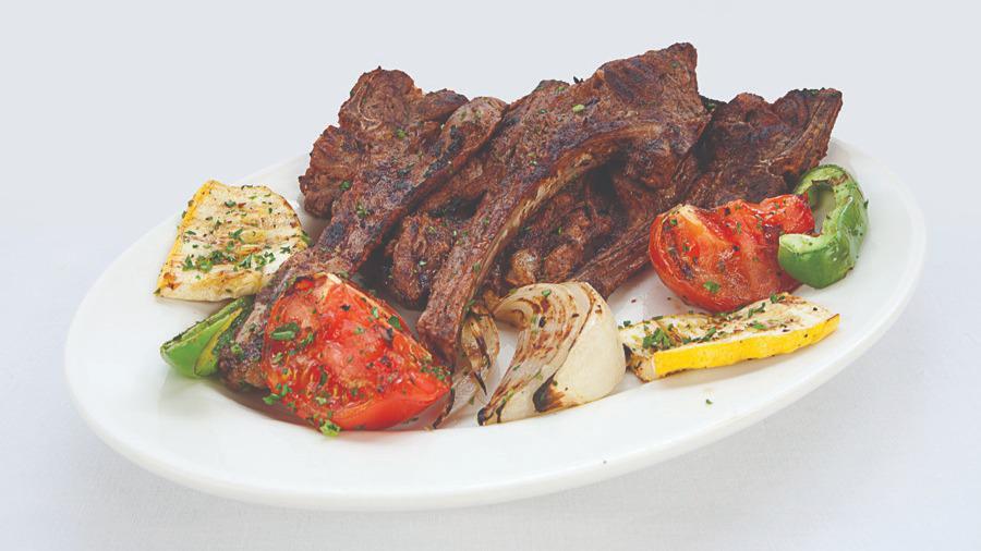 Lamb Chops · Savory lamb chops grilled to temperature served with grilled vegetables and our famous hummus.