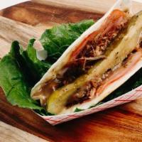 Cubano Taco. · Roasted pork, sliced ham and cheese, grilled together and served with pickle and Mojo sauce