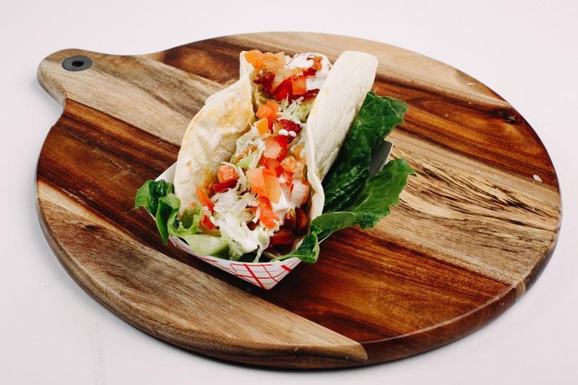 Chicken Bacon Ranch Taco. · Grilled chicken served with crispy bacon, shredded lettuce, diced tomatoes and topped with buttermilk ranch