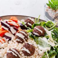 Buddha Bowl · Vegan. Homemade falafel, couscous, roasted carrots, kale, beets, topped with seeds, and hous...