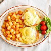 Classic Eggs Benedict · Two poached eggs, and Canadian bacon atop English muffin halves. Topped with hollandaise sau...
