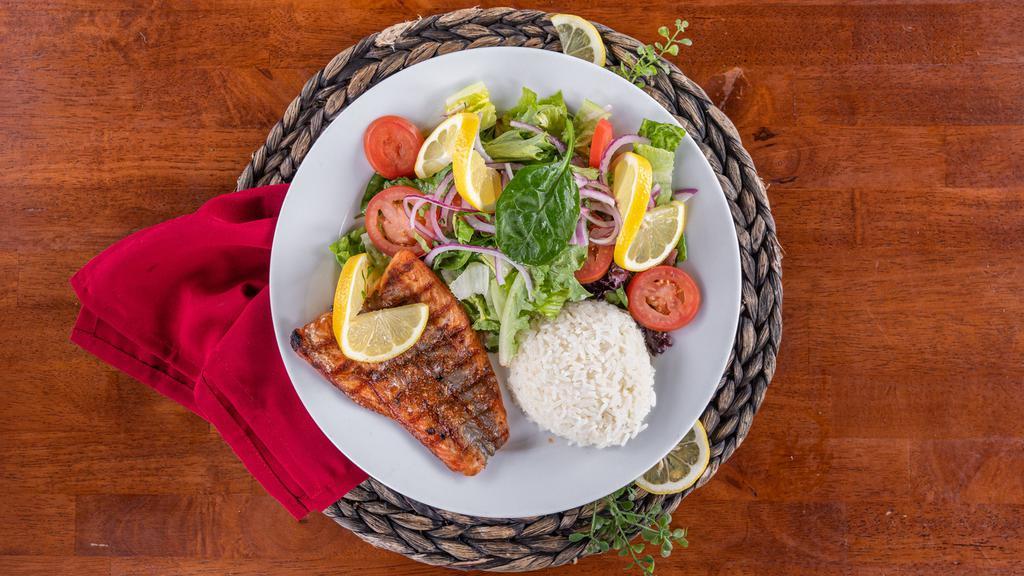 Fillet Of Atlantic Salmon · Grilled fresh fillet of salmon topped with a feta dill sauce, served with a mixed green salad and rice pilaf.