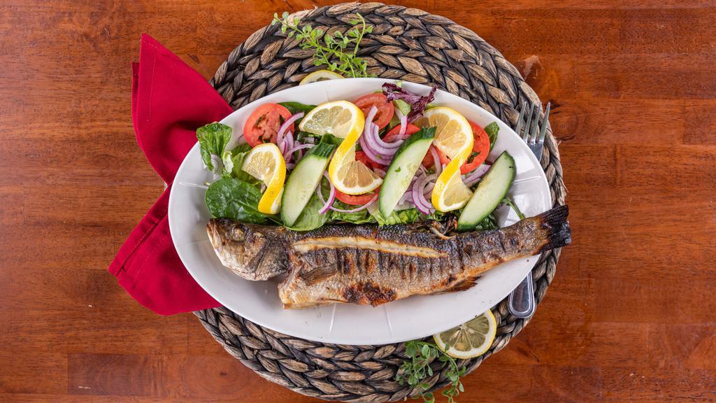 Grilled Whole Fish · Bronzini grilled over an open flame, served with mixed green salad tossed with olive oil and lemon dressing.
