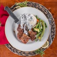 Lamb Chops · Delicately marinated and char-broiled lamb chops topped with oregano leaves.