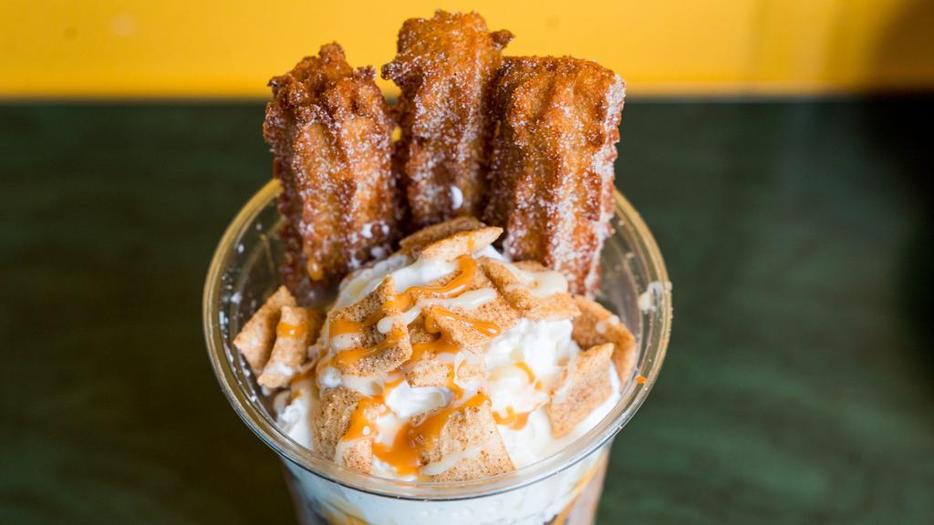 Churro Sundae · Two scoops icecream churos, whipped cream, cinnamon crunch caramel and a sweet drizzle.