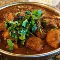 Dhaba Chicken Curry · Chicken pieces cooked in onion tomato gravy for an authentic dhaba style chicken curry.