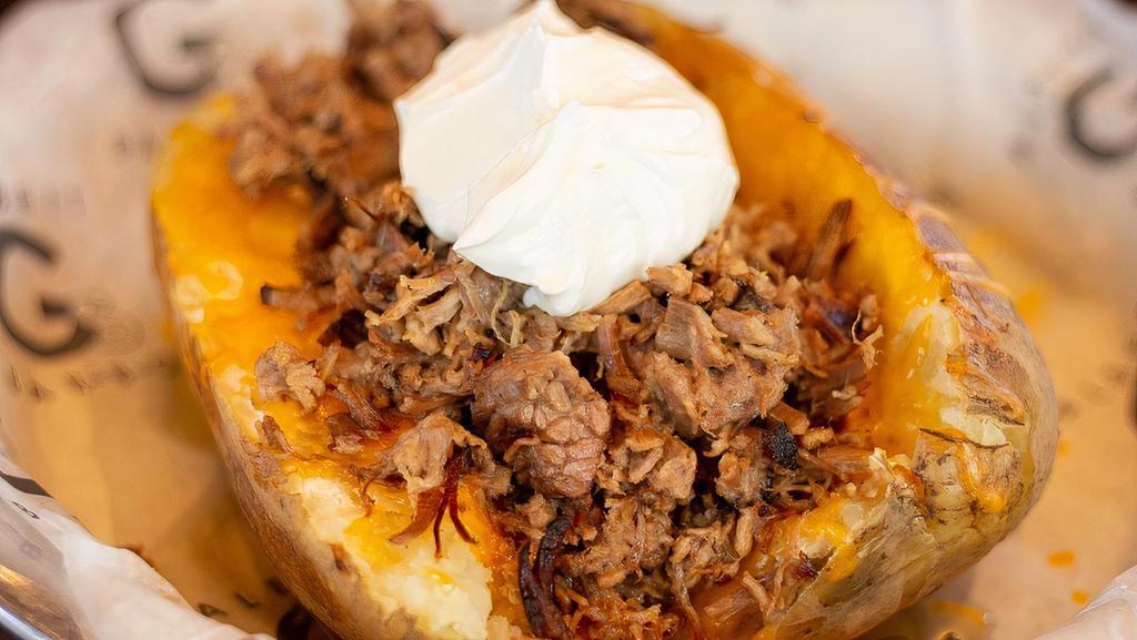 Smoked Idaho Potato · A giant seasoned potato loaded with butter, sour cream, and cheese. Your choice of chopped brisket, pulled pork, or hickory bacon chunks.