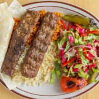 Lamb Adana  · 2 grilled skewers of ground lamb seasoned with red peppers comes with rice and salad