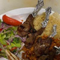 Lamb Chops · 4 pieces lambs chops seasoned and grilled comes with rice and salad