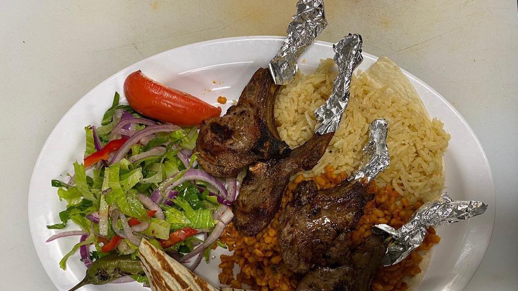Lamb Chops · 4 pieces lambs chops seasoned and grilled comes with rice and salad