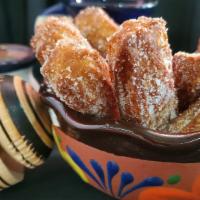 Churros · 4 Fried dough sticks with Mexican Cinnamon & sugar blend served with choice of sauce
Dulce d...
