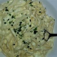 Fettuccine Alfredo · Homemade Alfredo sauce with Parmesan cheese and a touch of garlic.