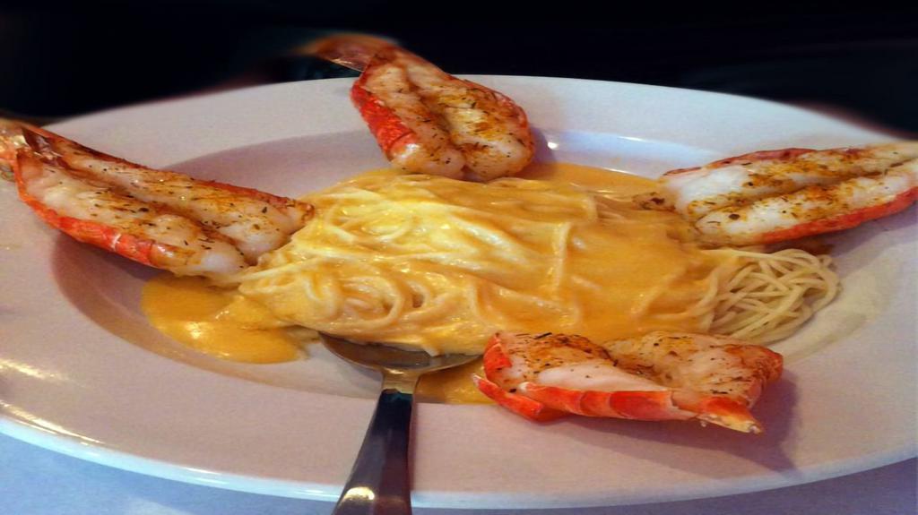 Colossal Shrimp · Four huge shrimp broiled with our special seasonings and served over angel hair pasta with lobster cream sauce.