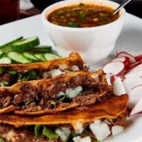 Quesa-Tacos · (Order of 3) Cheese and birria meat atop a toasted corn tortilla. Topped with onion and cila...