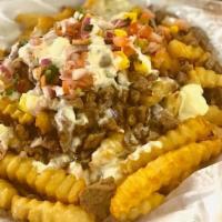 Papas Dinamita - New!! · A crispy bed of french fries topped with your choice of meat, fresh made pico de mango and w...