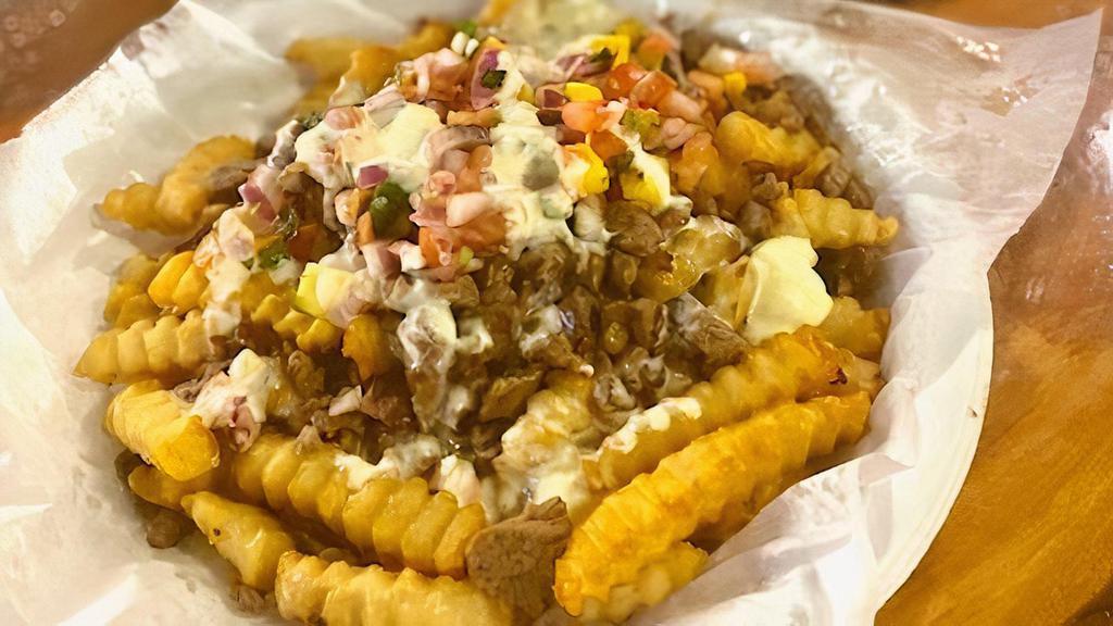 Papas Dinamita - New!! · A crispy bed of french fries topped with your choice of meat, fresh made pico de mango and white cheese dip, and salsa on the side.