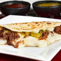 Suiza · Large flour tortilla stuffed with cheese, costilla (beef spare ribs), onion, cilantro and gr...