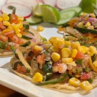 Vegan Tacos Poblanos · Fried Poblano pepper, sauteed onions and tomato topped with Pico de mango, and corn.  Served...