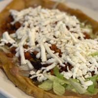 Sope Con Carne/ With Meat · Handmade tortilla topped with pinto beans, lettuce, queso fresco, and your choice of meat.