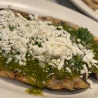 Huarache Sencillo/ Without Meat · Handmade tortilla with black beans inside. Topped with salsa, queso fresco, and onions.