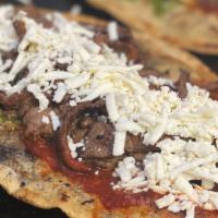 Huarache With Bistec · Handmade tortilla with black beans inside. Topped with salsa, queso fresco, onions, and Bist...
