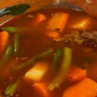 Mole De Olla · Slow-cooked braised beef and vegetable soup in guajillo sauce. (vegetables include corn, car...