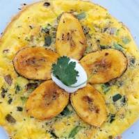 Plantain Frittata · Fluffy eggs with sweet plantain, green peppers, onion and cheese. Finished in the oven and t...