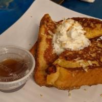 Coquito French Toast · A house specialty. Delicate blend of coconut milk, vanilla and cinnamon. Topped with shredde...