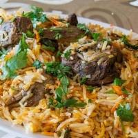 Goat Biryani · House marinated goat meat prepared with green chili tomatoes, onions, spices, and steamed in...