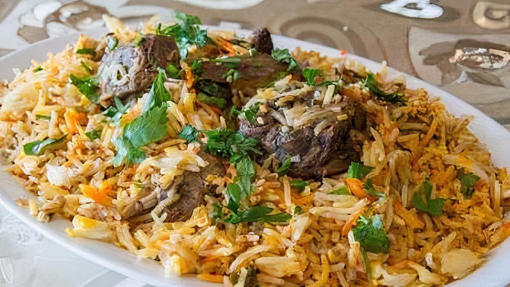 Goat Biryani · House marinated goat meat prepared with green chili tomatoes, onions, spices, and steamed in rice.
