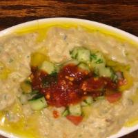 Baba Ghanoush · House roasted eggplant mixed with tahini, herb and spices. Topped with olive oil.