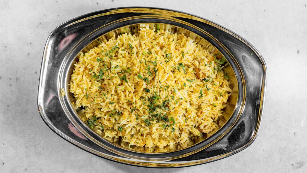 Chicken Biryani · A Mughlai dish prepared with chicken and green peas with saffron flavorful rice, garnished with raisins and cashews.