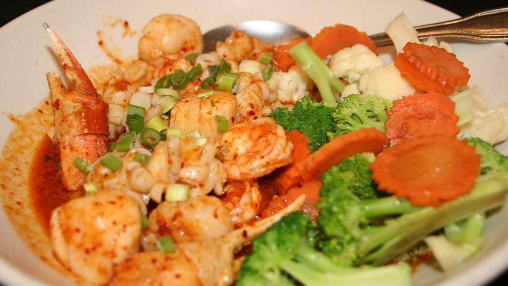 Fisherman'S Delight · Spicy. Shrimp, scallops, squid, and crab claws stir fried with spicy red curry. Served with steamed vegetables.