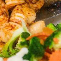 Shrimp & Scallops In Garlic Sauce · Fresh garlic and white wine enhance tender North Atlantic scallops and gulf shrimp. Served w...