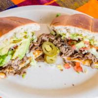 Tortas · Un sándwich mexicano con tu elección de carne, mayonesa, queso derretido, aguacate, chile ja...
