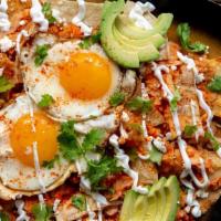 Chilaquiles · Two eggs, carne asada, rice and beans.