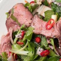 Thai Spicy Beef Salad · Sliced grilled beef with lime juice, onion, tomatoes, cucumber, scallion, and cilantro, hous...