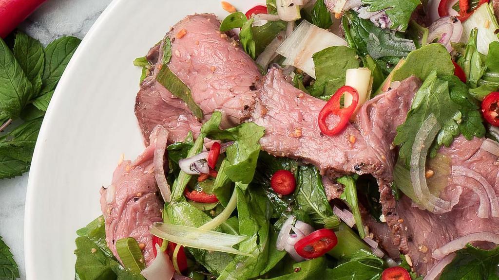 Thai Spicy Beef Salad · Sliced grilled beef with lime juice, onion, tomatoes, cucumber, scallion, and cilantro, house spices served on fresh greens.