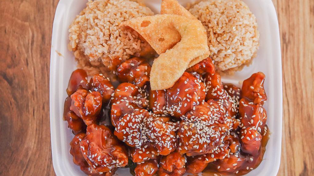 Sesame Chicken   · Deep fried battered dark meat chicken coated with sweet sauce and contains sesame seed on top with layer of broccoli underneath.
Served with rice and one crab rangoon.