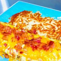 Supreme Omelet · Made with bacon, sausage, ham, tomato, and onion, topped with monterey jack and cheddar mix.