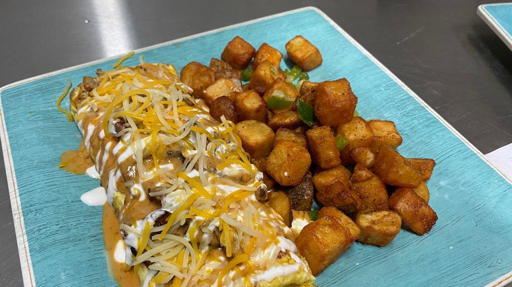 Chipotle Steak Omelet · Made with steak, tomato, onion, mushrooms, topped with chipotle sauce and sour cream. Served with breakfast potatoes or pancakes.