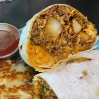 Breakfast Burrito · Breakfast burrito made with bell pepper onions tomatoes three eggs cheese potatoes and your ...