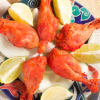 Tandoori Chicken · Skinless chicken marinated in a mixture of yogurt, aromatic spice and baked to a succulent i...