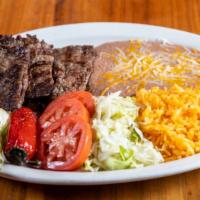 Carne Asada · Gluten-Free. Grilled skirt steak tender served with rice, beans, sour cream and guacamole.
