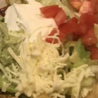 Taco Salad · A crispy bowl filled with beef or chicken, beans lettuce, tomatoes, cheese, and sour cream.