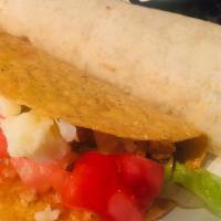 El Grande Burrito · Choice of chicken or steak, stuffed with rice and beans.  Served with sour cream and guacamo...