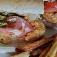 Shrimp Po-Boy · Comes on french bread with lettuce, pickles, tomatoes, with house sauce and fries