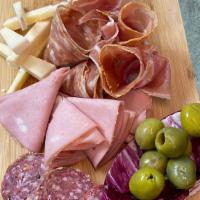 Charcuterie Board · A selection of fine cheeses and cured meats with fig confit and olives.