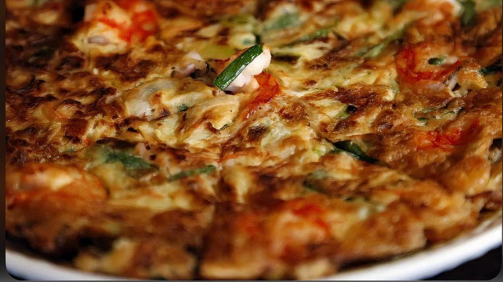 Seafood Pancake · A Pancake-like Korean dish made from a batter of eggs, wheat flour, rice flour, green onion and assorted seafood