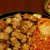 Grilled Pork Belly · Grilled pork belly, kimchi, vegetables on a hot iron plate
